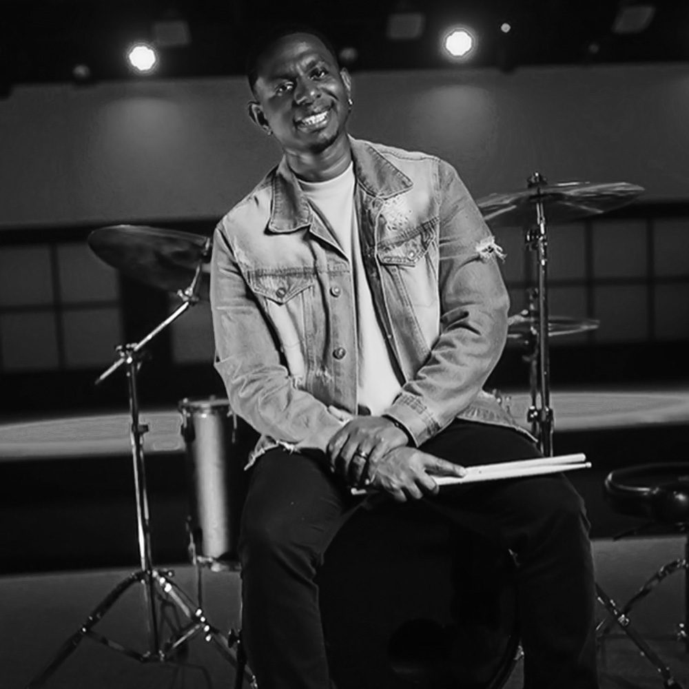 Hosea Butler, a U.S. military veteran and music director, is known for his vibrant drumming style and collaborations with notable artists in various genres.