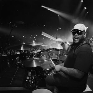 Marcus Thomas, a versatile drummer, is known for his dynamic playing style and adaptability across genres, collaborating with various artists in live and studio settings.