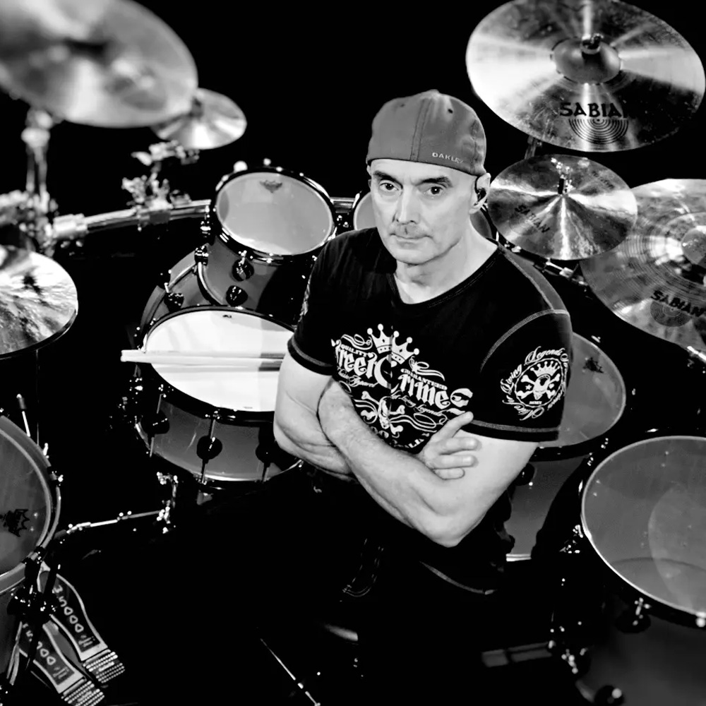 Virgil Donati, a renowned drummer and composer, is known for his innovative style and collaborations with prominent artists, as well as his contributions to music education through books and videos.