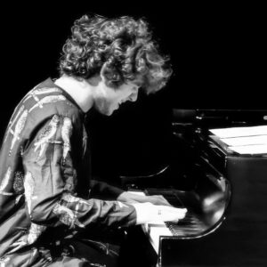 Javier Jbara performing on piano, showcasing his musical talent and dedication to jazz education.